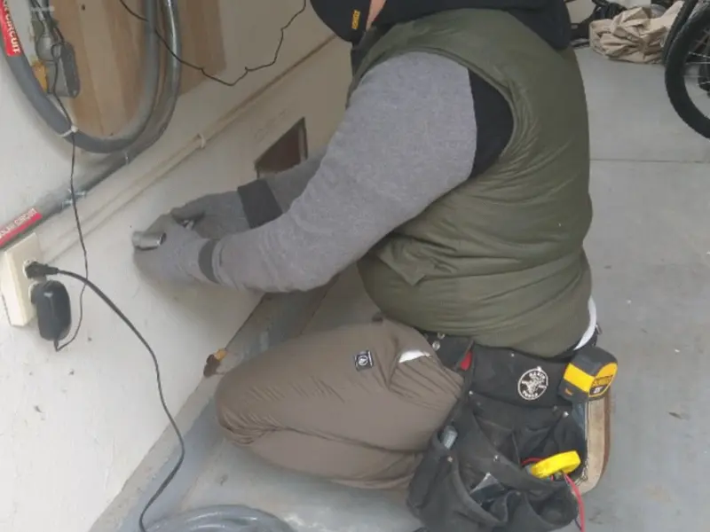 Electrician performing outlet wiring in a Northlake garage